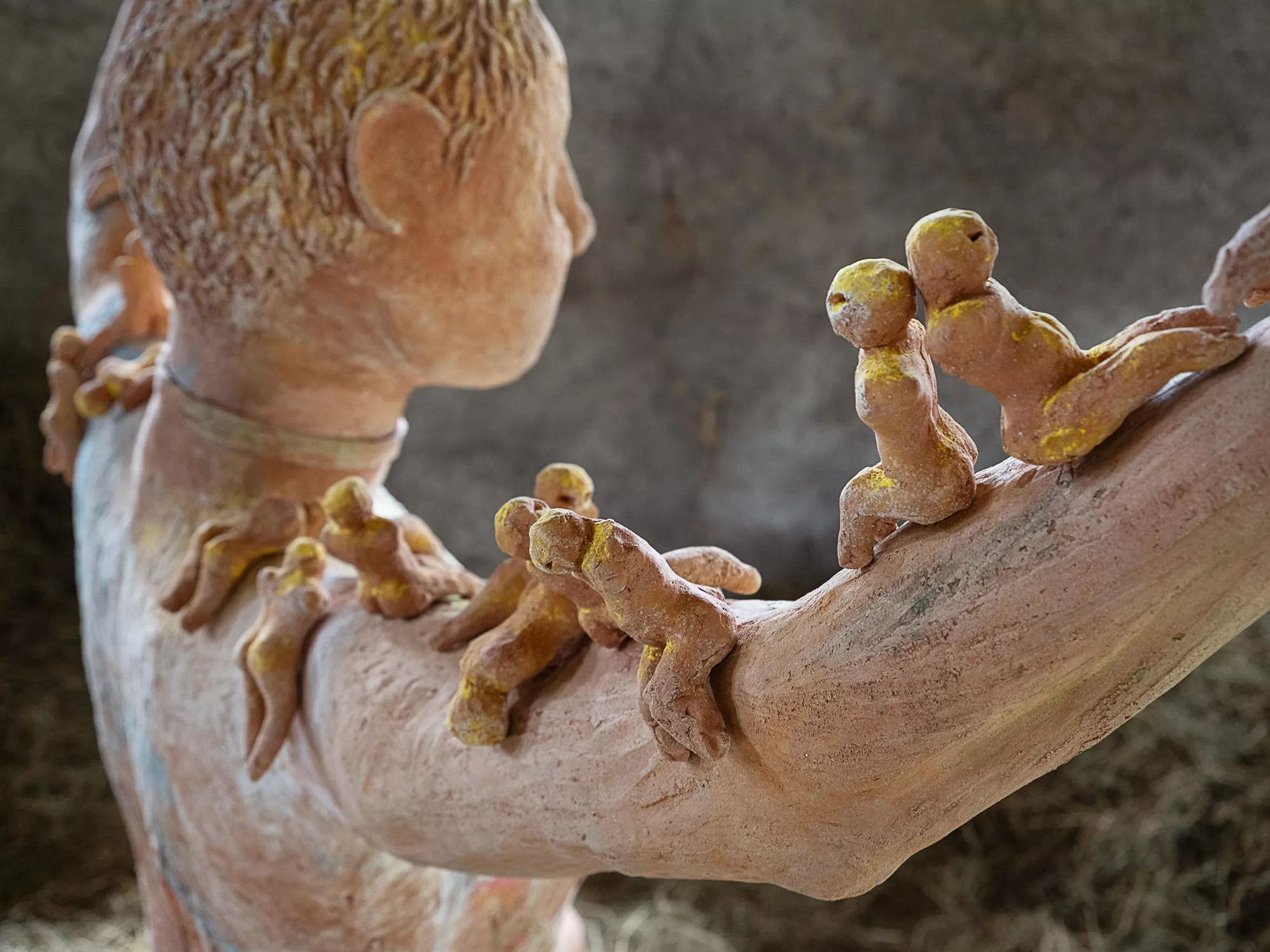Gaia Fugazza - Gaia Fugazza, Mother of Millions, 2025, detail of the small figures along the sculpture’s arm, with the head visible in the background.